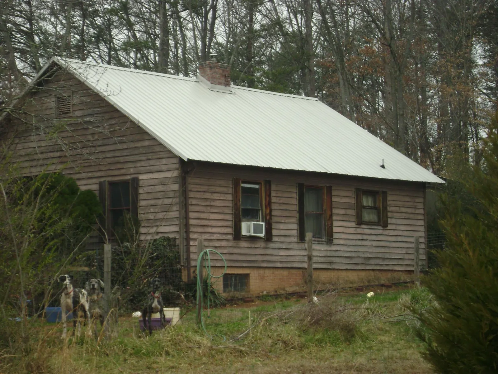 White metal roof on an old wood sided farmhouse, from a Metal Roof Installation job in Moseley